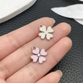 Pink enamel clover pendant and silver brushed metal clover charm held in hand - Pink Enamel Rhinestone Clover (21902)