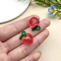 Macro view of peach-shaped resin pendant with green leaf and hanging ring - Rose Red Apple (22168)
