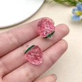 Macro shot of 2-piece pink acrylic strawberry pendants with green leaves for jewelry DIY - Transparent Pink Strawberry (22166)