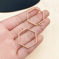 Primer plano de marcos hexagonales dorados para joyas DIY sostenidos en la mano - Bisel de Marco Hexagonal (22242)