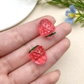 Macro shot of a pair of translucent pink strawberry charms with green leaves for DIY jewelry - Transparent Rose Red Strawberry (22165)