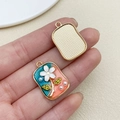 Detailed macro view of the double-sided enamel floral pendant with faux pearl accents - Pink Blue Square Monet Garden Floral Leaf (22115)