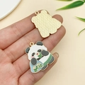 Detail of panda enamel charm showing intricate front design and textured gold metal back - Panda Eating Zongzi (23039)