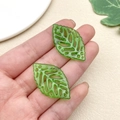 Detailed view of translucent green acrylic leaf pendants with intricate hollowed veins - Hollow Long Leaf (22151)
