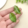 Macro shot of green translucent leaf pendants with fine veins and pre-drilled holes - Light Green Osmanthus Leaf (33x19mm)