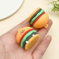 Detailed view of miniature burger charms with cute smiley faces held in hand for size scale - Cute Expression Burger