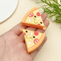 Close-up of DIY pizza pendants with detailed colorful mushroom and pepperoni toppings - Triangle Pizza