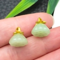 Close-up of a pair of lotus seed pod pendants in faux jade with gold metal tops - Light Green Glace Zinc Alloy Lotus Pod (22202)