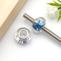 Close-up of blue glitter resin beads with silver metal cores for DIY charm bracelets - Round Granular Sequined Large Hole Bead (17969)