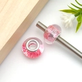 Macro shot of gradient pink resin charm bead with silver core and sparkling glitter detail - Round Granular Sequined Large Hole Bead (17964)