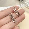 Close-up of a silver four-link iron chain accessory held by hand for jewelry DIY - White K Four-Section Chain (1.4mm Thick, 27x7mm)