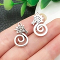 Detailed view of silver seahorse pendants with intricate spiral tails held in hand - Seahorse Style (22305)