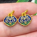 Macro detail of golden lucky cloud charms with Ping An relief and enamel inlay - Blue Enamel Fortune Peace Lock