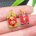 Detailed close-up of Chinese style red enamel charms with golden Peace characters - Red Enamel Safe Amulet Pendant
