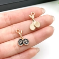 Miniature gold and black tennis racket charms for DIY sports jewelry and keychains - Pair of Rackets (21734) / 20x12mm
