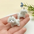 Close-up of cute white flocked puppy charms with silver rings held in hand - White Lamb Alpaca (23138)