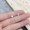 Silver round zinc alloy magnetic jewelry clasps shown on a fingertip for size - Silver Cylinder Shape (19847)