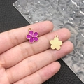 Detailed macro view of a purple enamel daisy pendant charm with a gold alloy base - Purple Enamel Flower (11881)