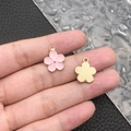 Detail of pink enamel flower pendant with gold textured back and hanging loop - Pink Enamel Flower (11880)