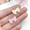 Detail of pink oil-dripped and gold bow charms with fine metallic textures for DIY jewelry - Pink Bowknot Tie