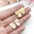 Detail of pink enamel bow charm and golden metal pendant with tiny pearls - Pearl Bowknot