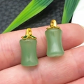 Bamboo style faux jade pendants with golden leaf charms shown on a fingertip - Green Glace Zinc Alloy Bamboo Segment (22221)