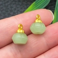 Light green faux jade persimmon pendants with gold alloy loops shown on a finger - Light Green Zinc Alloy Glace Pumpkin Bead (22261)