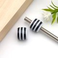 Cylindrical black and white striped resin beads on a metal rod for DIY jewelry making - Round Wide Striped Barrel Bead (17937)