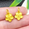 Matte gold plum blossom charm pendants for DIY jewelry making, 2 pieces shown on fingertip - Solid Antique Gold Sakura Flower Charm