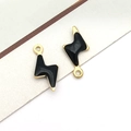 Macro view of gold-plated lightning bolt charms with black enamel finish for DIY jewelry - Gold Black