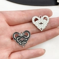 Macro detail of heart-shaped gothic snake pendants showing front and back textures - Heart Twin Snake Style (19391)
