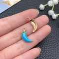 Close-up of sky blue enamel chili pendants with gold-plated textured back for DIY jewelry - Blue (23377)
