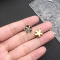Enamel black flower daisy pendant with crystal center and golden metal back - Black Enamel Rhinestone Cherry Blossom (11905)