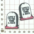 Detailed view of Halloween tombstone pendants with Love U To The Tomb text on a scale - Pink White Acrylic LOVE Grass Tombstone (19315)