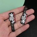 Detail of acrylic chef knife charms with gothic floral patterns and red blood splatters - Black Acrylic Flower With Blood Knife (19281)