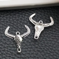 Macro detail of antique silver bull head pendants with vintage engraved patterns - Halloween Skull Bull Head Style (16967)