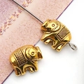 Macro detail of golden elephant alloy beads with intricate textures for DIY jewelry making - Bright Gold Elephant Spacer Bead (10136)