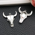 Pair of antique silver bull skull charms showing front and back detail for DIY jewelry - Smooth Bull Head Style (18711)