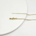 Close-up of golden stainless steel box chain necklace with lobster clasp and needle end - 14K Gold Universal Adjustable Box Chain Style