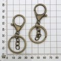 Detail showing vintage bronze lobster clasp with key ring and chain on a grid background - Antique Bronze With Chain (12744)