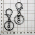 Detail view of two gunmetal alloy lobster clasps with keychains measuring 75mm length - Gun Black With Chain (12745)