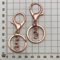 Detail view of rose gold plated keychain ring and lobster clasp over measurement scale - Rose Gold With Chain (12746)