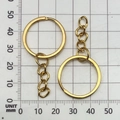 Close-up of golden electroplated DIY keychain rings with 4-link chains on a measuring grid - Gold 25mm Ring With Chain (13506)