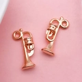 Detailed macro view of rose gold trumpet-shaped metal DIY jewelry pendant charms - Music Horn