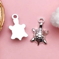 Silver turtle ocean charms for DIY jewelry making showing front and back texture - Antique Silver Sea Turtle (10359-Zinc Alloy, 17.5x10mm, 1.2g)