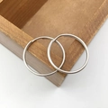 Polished silver metal hoop earrings displayed on a minimalist wooden texture box - White K 25mm Split Ring (13067)