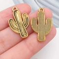 Golden cactus shape alloy pendant for DIY jewelry making shown on fingertip - Cactus (19228)