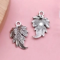Vintage silver alloy leaf charms for DIY jewelry making shown on pink background - Ancient Silver Leaf (3498)