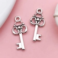Pair of vintage silver alloy key pendants with intricate hollow patterns for DIY jewelry - Small Key (17326)