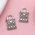 Pair of vintage Tibetan silver lock charms with antique floral relief for DIY jewelry - Key Lock (17356)